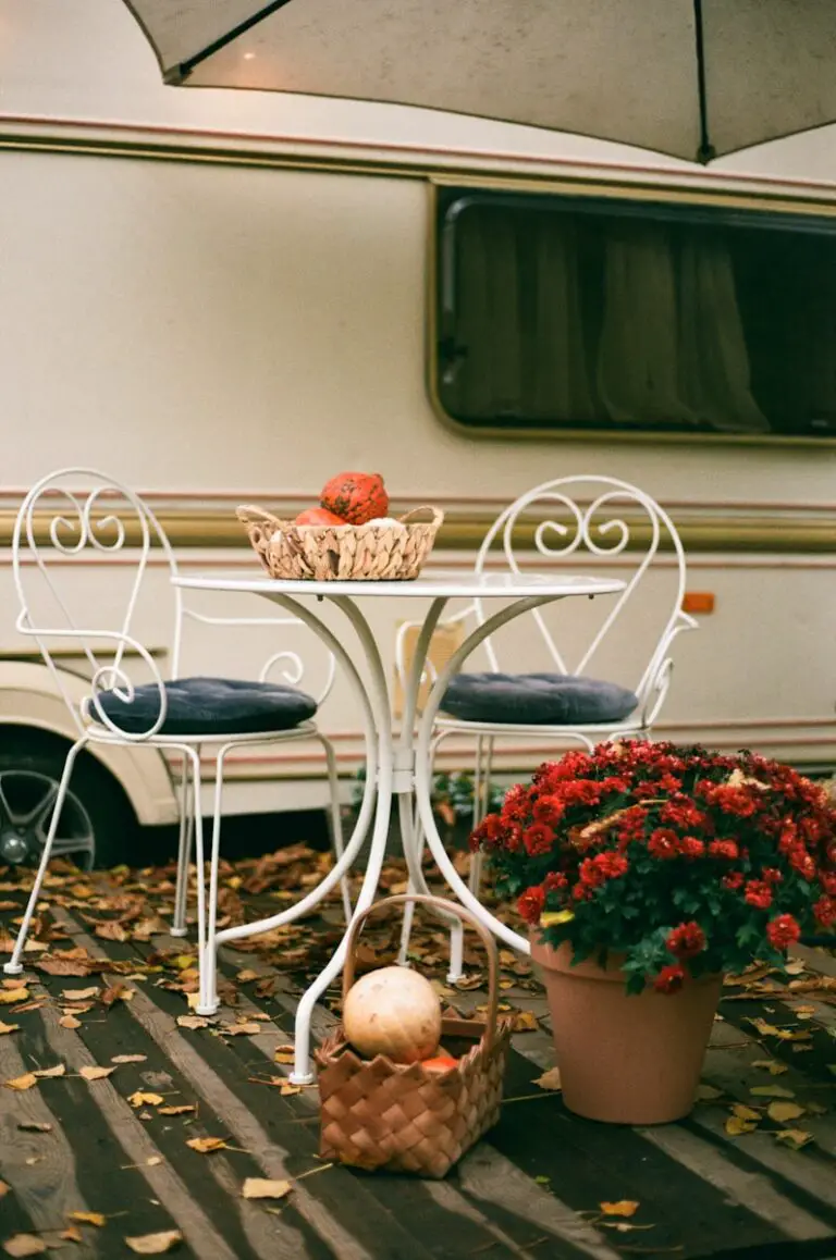 red and white flowers on white table next to an RV