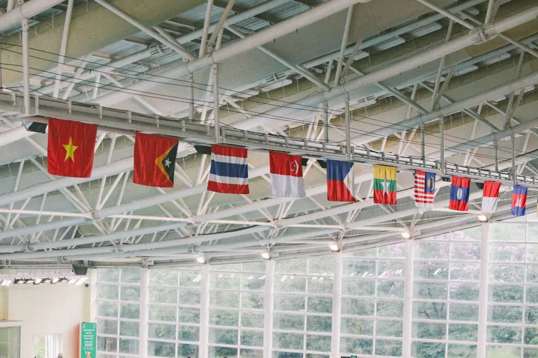 a group of flags hanging from the ceiling of a building