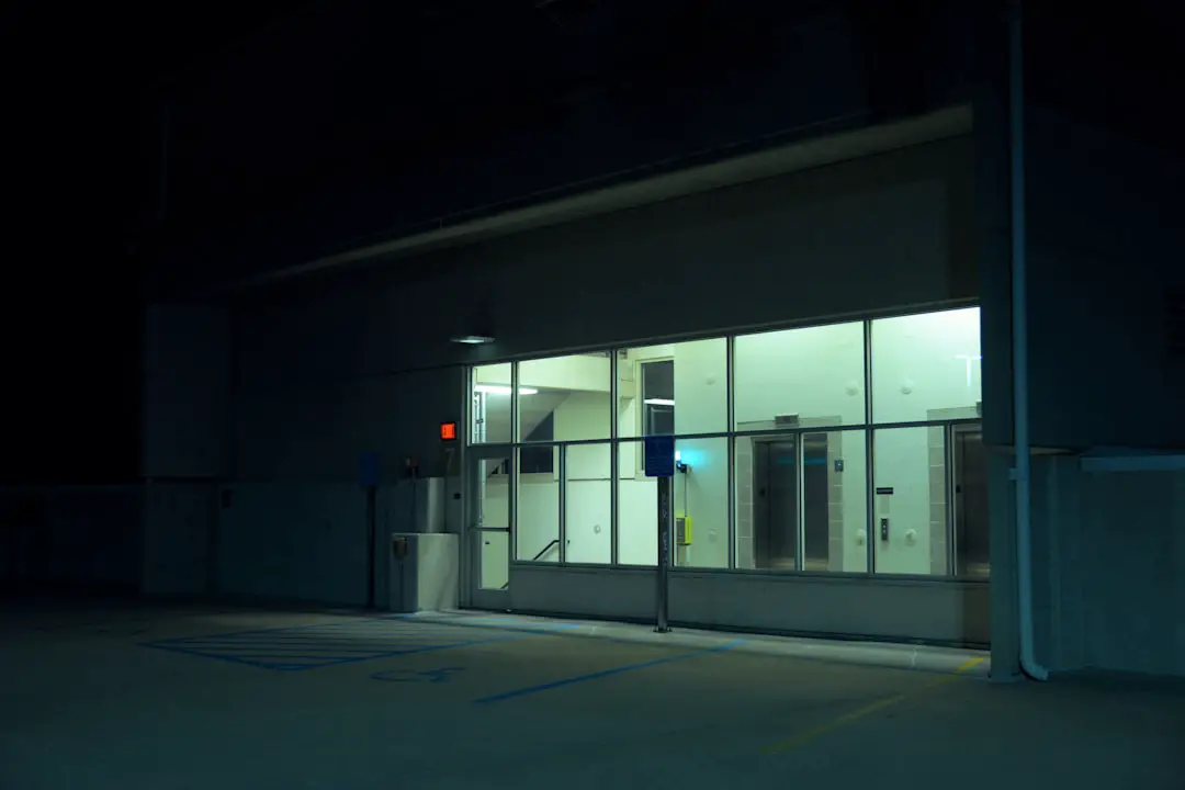 an empty parking lot at night with the lights on