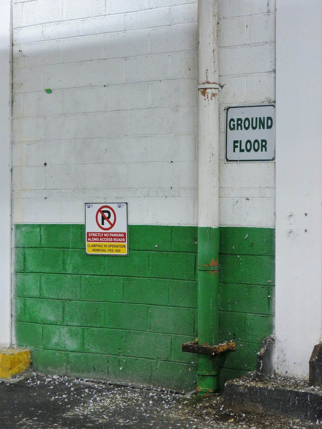 a green and white building with a no parking sign