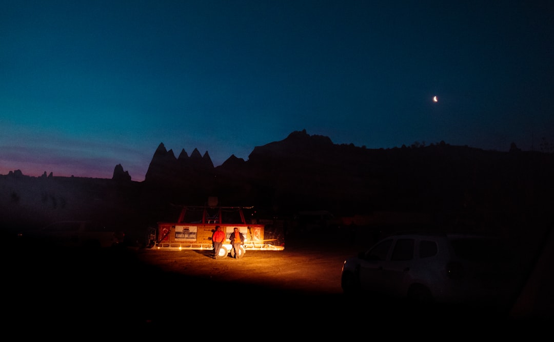 a couple of trucks parked in a field at night